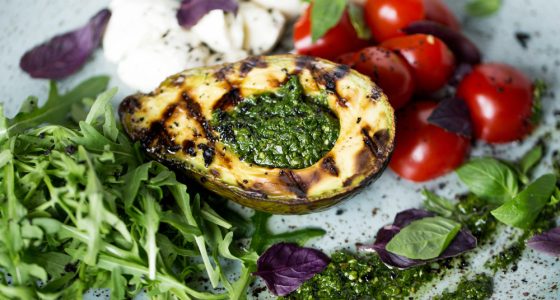 Grilled,Avocado,With,Cherry,Tomatoes,Basil,Pesto,Sauce,Mozzarella,Cheese