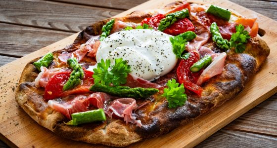 Roman,Pinsa,With,Burrata,Cheese,,Ripened,Ham,And,Green,Asparagus