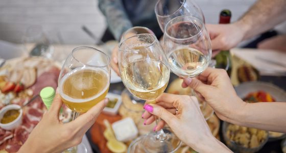 Celebrating with glasses of alcohol in hands. Happy female friends having good time.